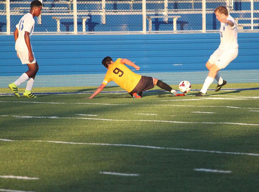 Senior Shai Yulish dives for the ball in the season opener against Independence. Photo by Livia Eppell.
