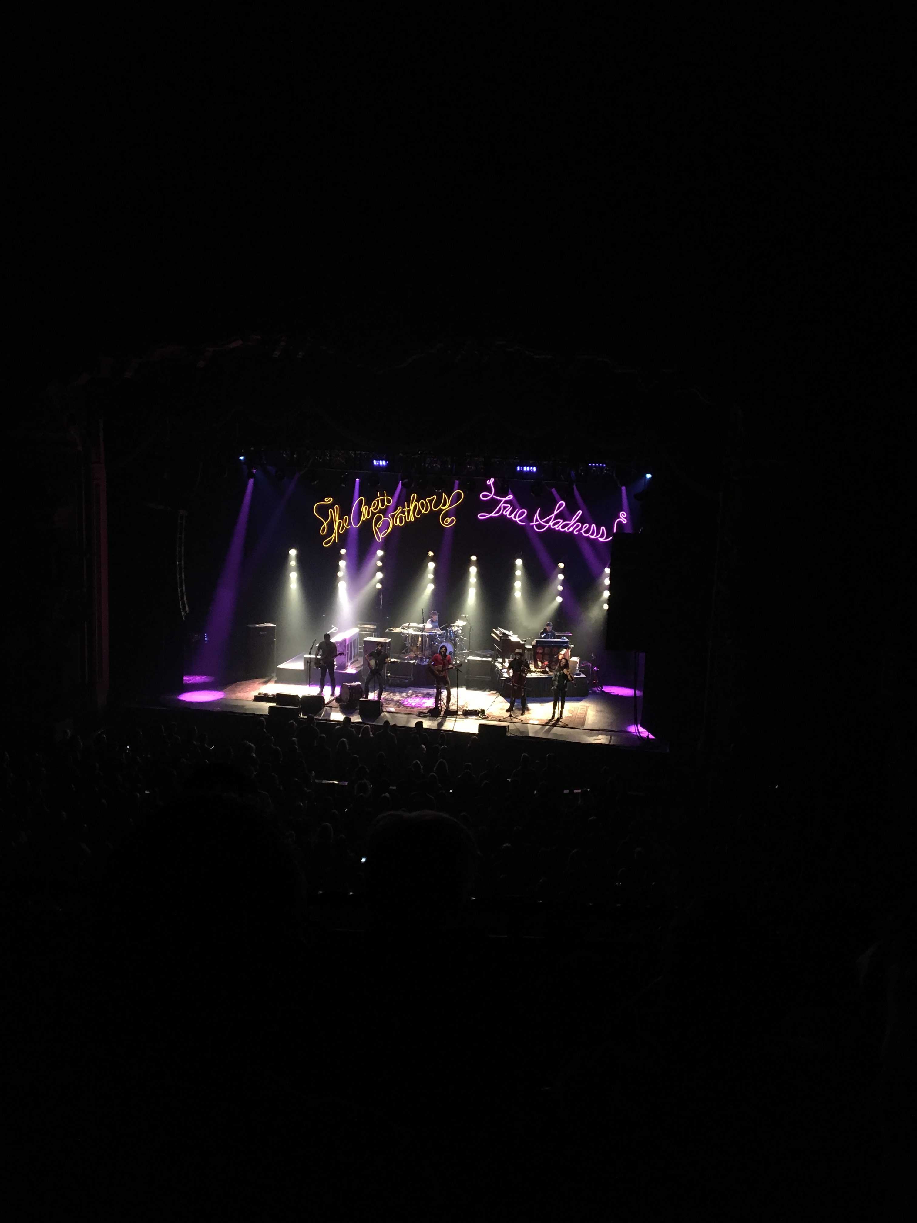 Suddenly, twenty feet above the stage, an orange neon light reading “The Avett Brothers” as well as purple neon lights reading “True Sadness”appeared. The lights hit my retinas and sent shivers down my spine. Photo by Ben Connor.