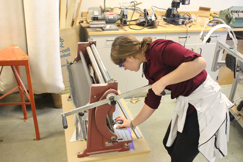 Sophomore Claire Bruening works on construction for the BHS robotics team. Photo by Bradford Douglas.