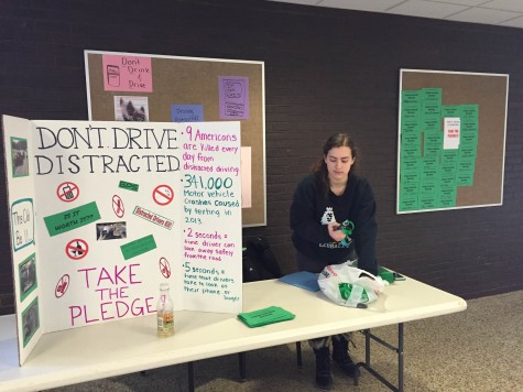 Juniors Natali Polonsky and Griffin Davis and seniors Ellie Levine, Bennett Woomer, Benji Roter, Isabel Millstein, Kendall Yulish and Max Babbush are encouraging students to eradicate their driving distractions. Behind their table is a pledge wall where students and teachers are pledging not to text, drink, or drive distracted in any other way. Levine feels that distracted driving is an important issue to bring attention to at BHS. “With open campus and many students driving to school, we want to make sure everyone in the community is safe,” she said.