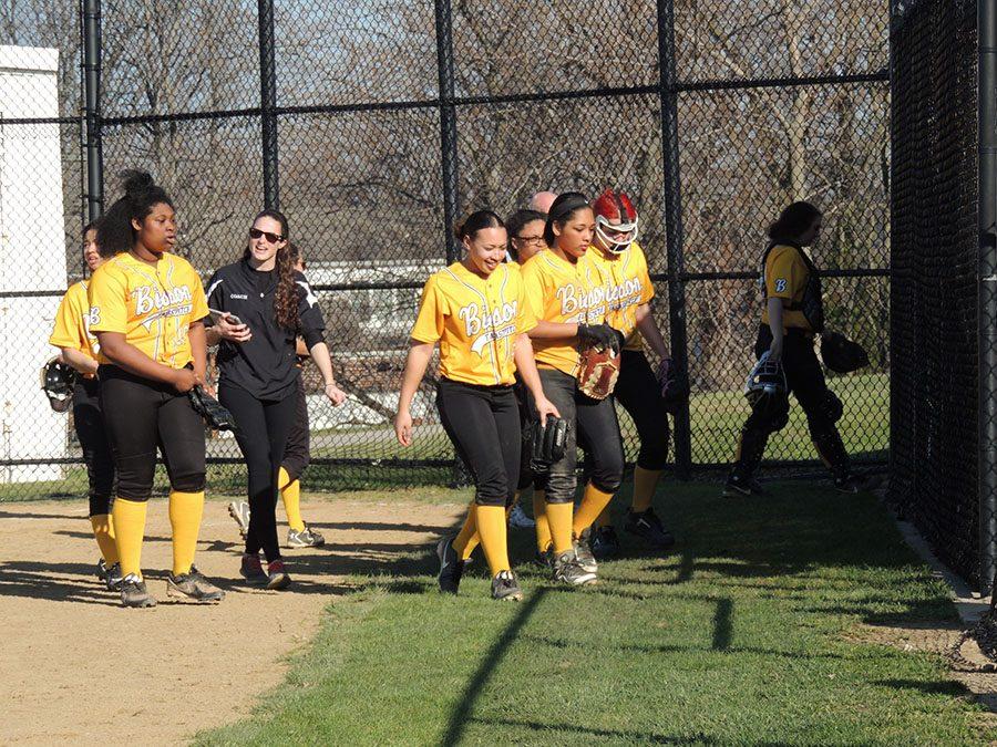 The Lady Bison softball team comes in from the field at a home game. Photo by Bradford Douglas.