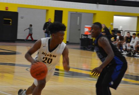 Sophomore Collin Albert makes a move against St. Martin de Porres on March 2. Photo by Joe Spero