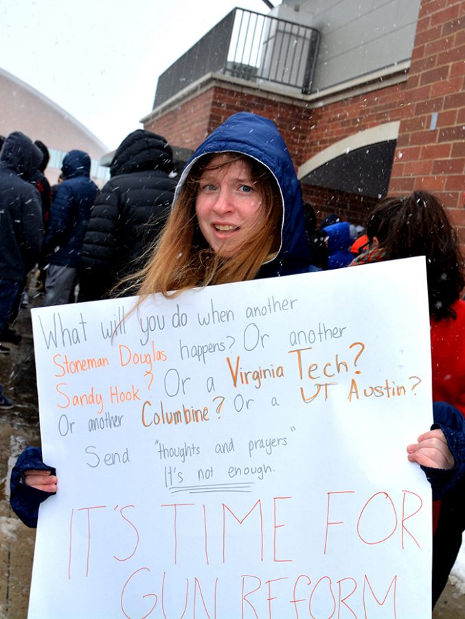 Freshman Rachel Cohen displays the sign she made for the March 14 walkout. Photo by Carrington Peavy