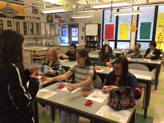 On March 6, senior Abby Brewer led a lung lab in which students watched a video of a lung surgery and made models of lungs using balloons and plastic bottles. Photo by Julia Woomer
