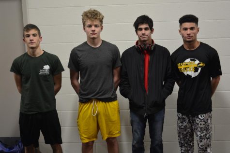 Left to right: Zach Kudroff placed fourth in 120 lb weight class, James Flowers placed fourth in 170 lb weight class, Paul Jacobs won first place in 132 lb. weight class and Michael Schmidt won third place in 138 lb. weight class. Not pictured: freshman Eisa Texiera won second place in the 126 lb weight class. Photo by Matthew Keyerleber