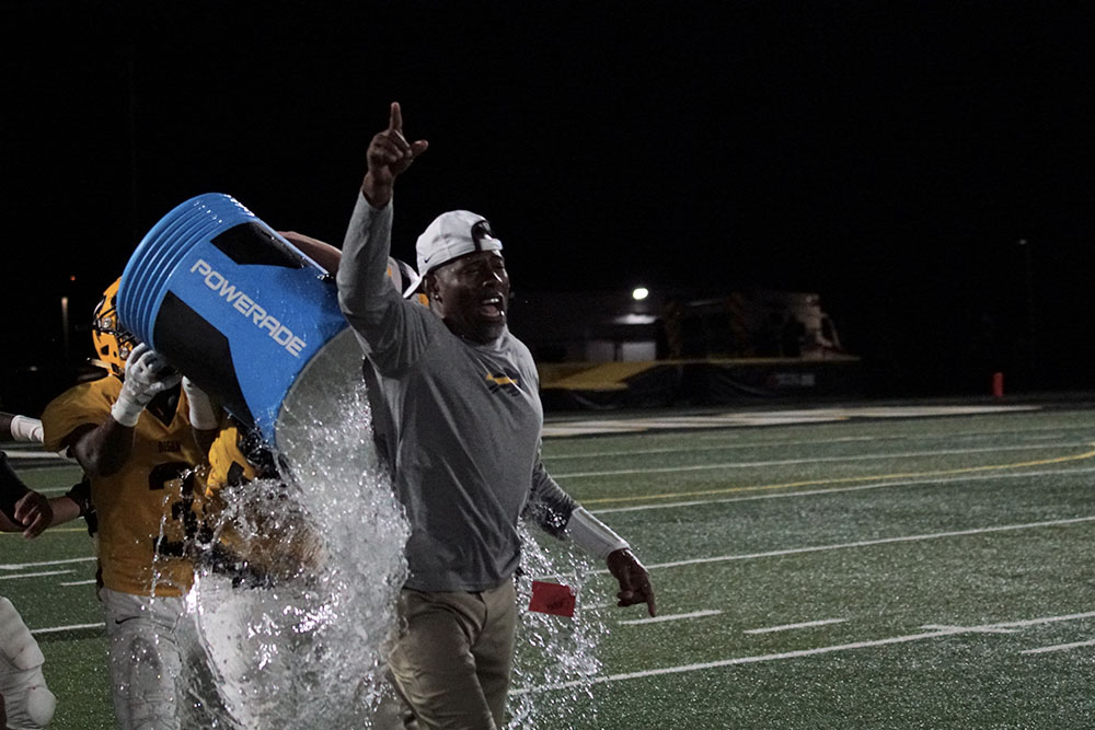 Coach Creel gets drenched in ice water after the first Bison win of the season over Orange.