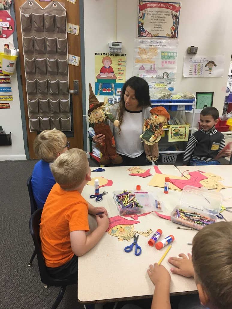 Mayfield High School senior Emmie Rotsky works on fall crafts with a group of elementary students.