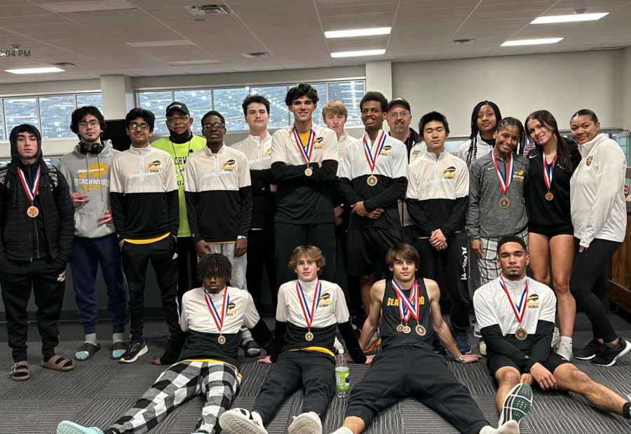 The+indoor+track+team+with+their+medals+after+the+March+3+tournament.