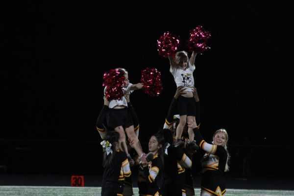 The cheer team stunts at the Sept. 22 Brooklyn game with special guests from Bryden elementary. 