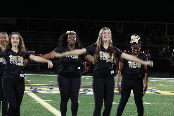 Stimpert (second from right) performing with the cheerleaders at last year's homecoming game. 