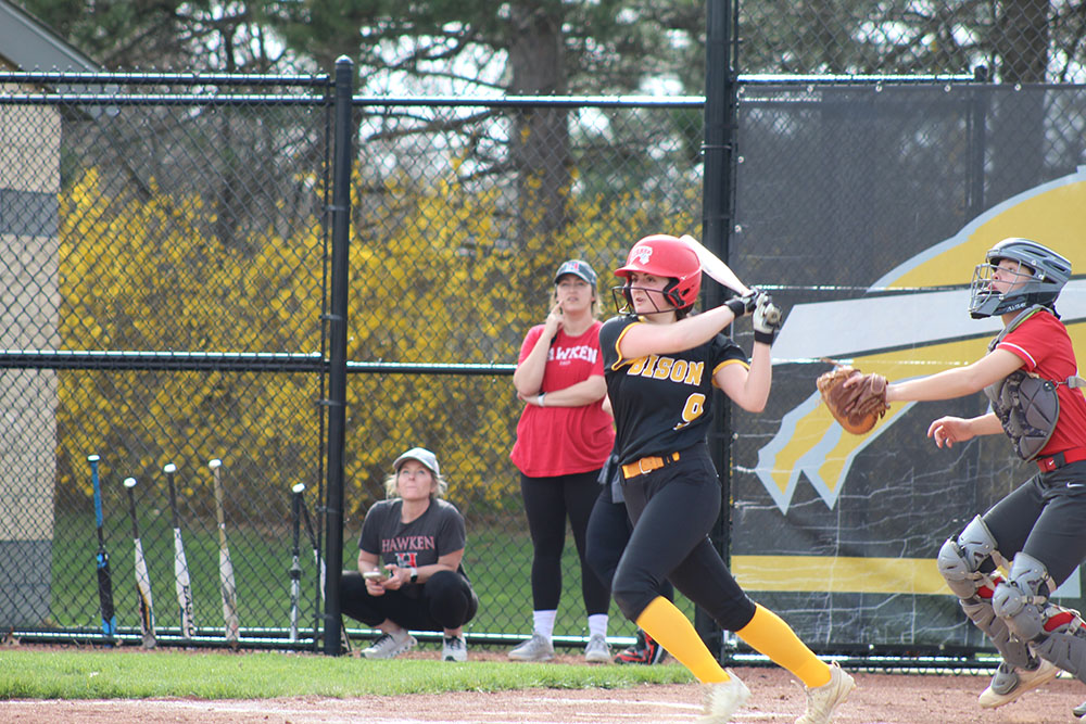 Freshman shortstop Lily Grover makes a hit and begins to run to first during the first Hawken game on April 9.
