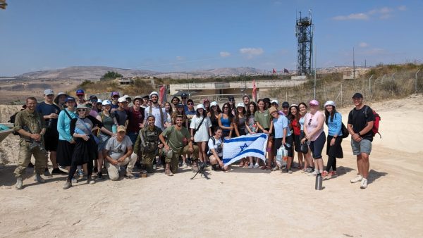 A travel group for Jewish students including junior Isaac Gorodeski as well as seniors Hudson Peters and Marlee Duchon at the Lebanese border with IDF soldiers. Photo courtesy of Isaac Gorodeski