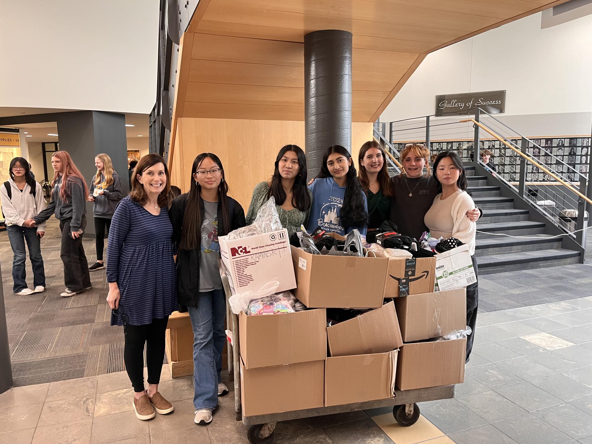 Class of 2026 adviser Pam Miller with class officers and the socks collected for the Bellefaire JCB. 