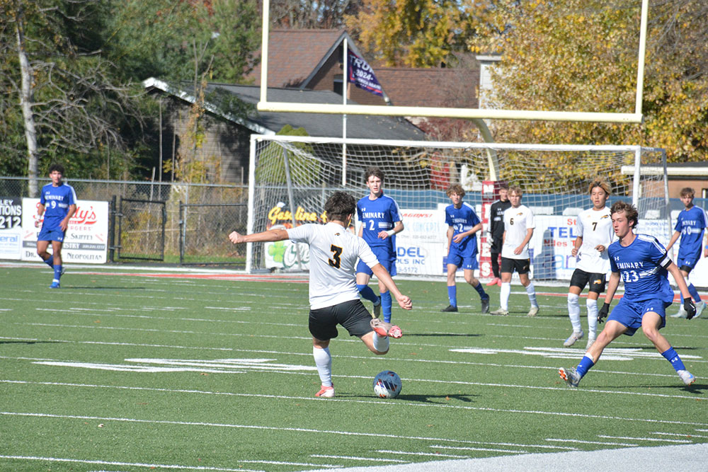 Junior center back Nate Brecher forcefully clears the ball away from the bison goal