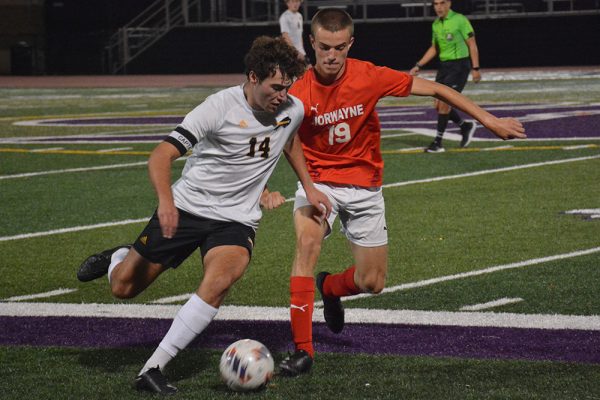 Senior co-captain Grant Keilin drives the ball up the outside during the regional semifinal game against Norwayne.