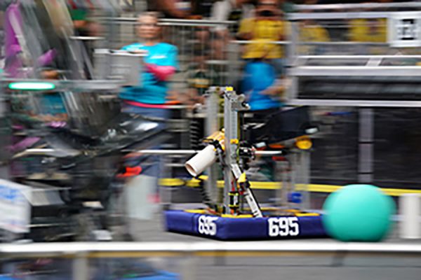 Team 695's robot 'goldfish' aligns to the scoring location with the coral game piece at the world championship in Houston.