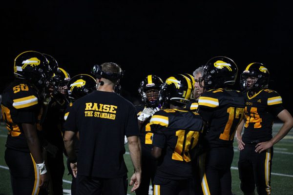 Coach Gonell huddles with the Bison during third quarter.
