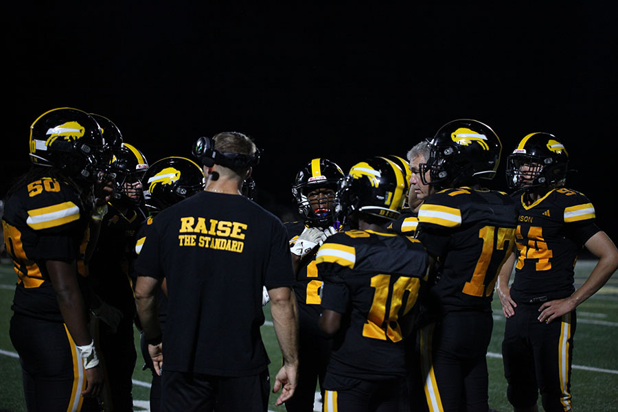 Coach Gonell huddles with the Bison during third quarter.
