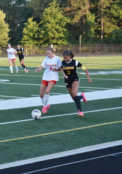 Junior Marley Readance looks to win the ball against a Fairview Park defender.
