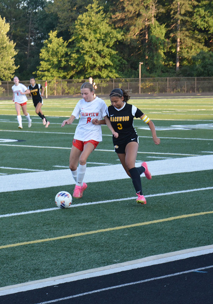 Junior Marley Readance looks to win the ball against a Fairview Park defender.
