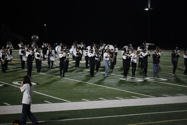 Alumni join the marching band and drill team at the Sept. 26 Homecoming game. 