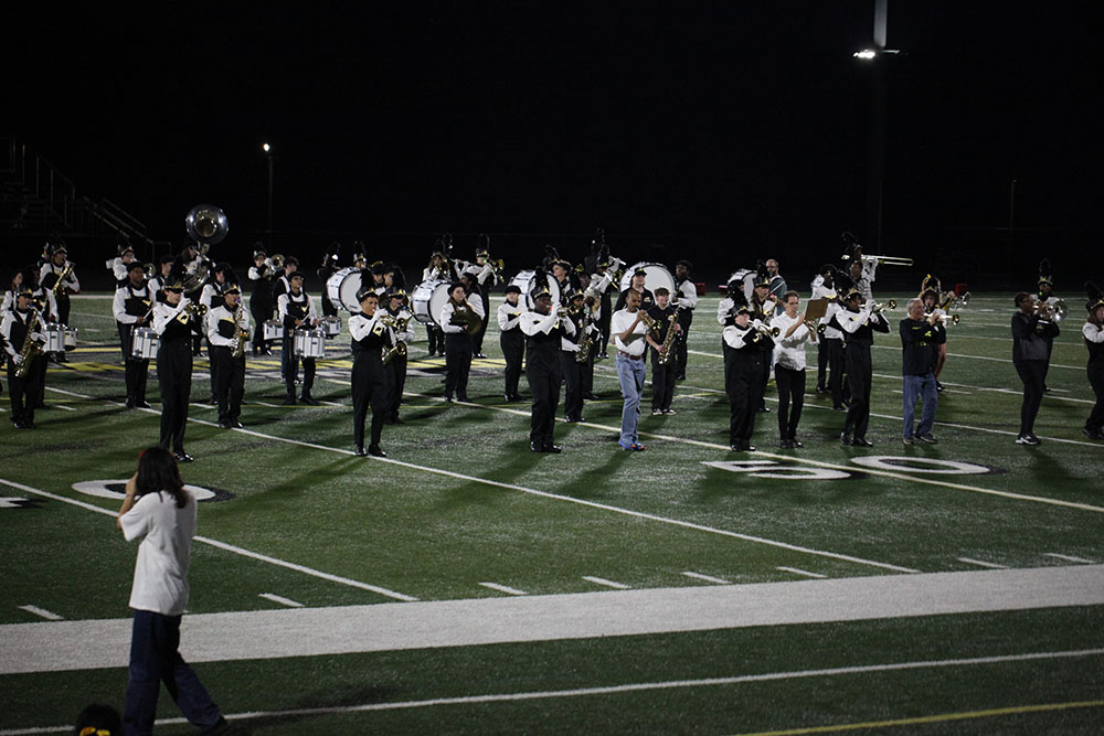Alumni join the marching band and drill team at the Sept. 26 Homecoming game. 