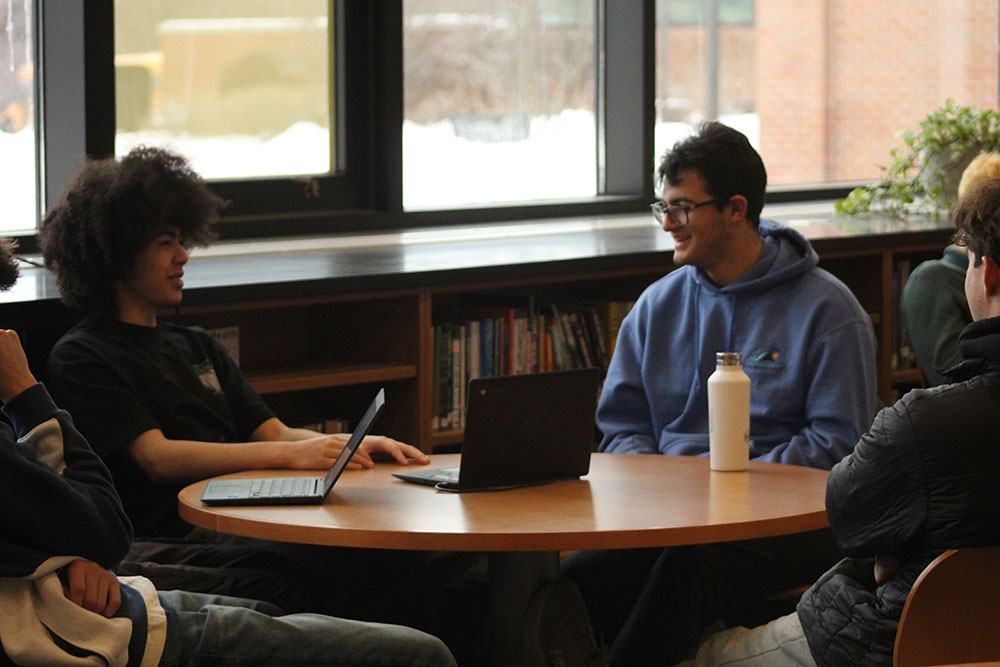 Students in the library are spending more time socializing face to face.
