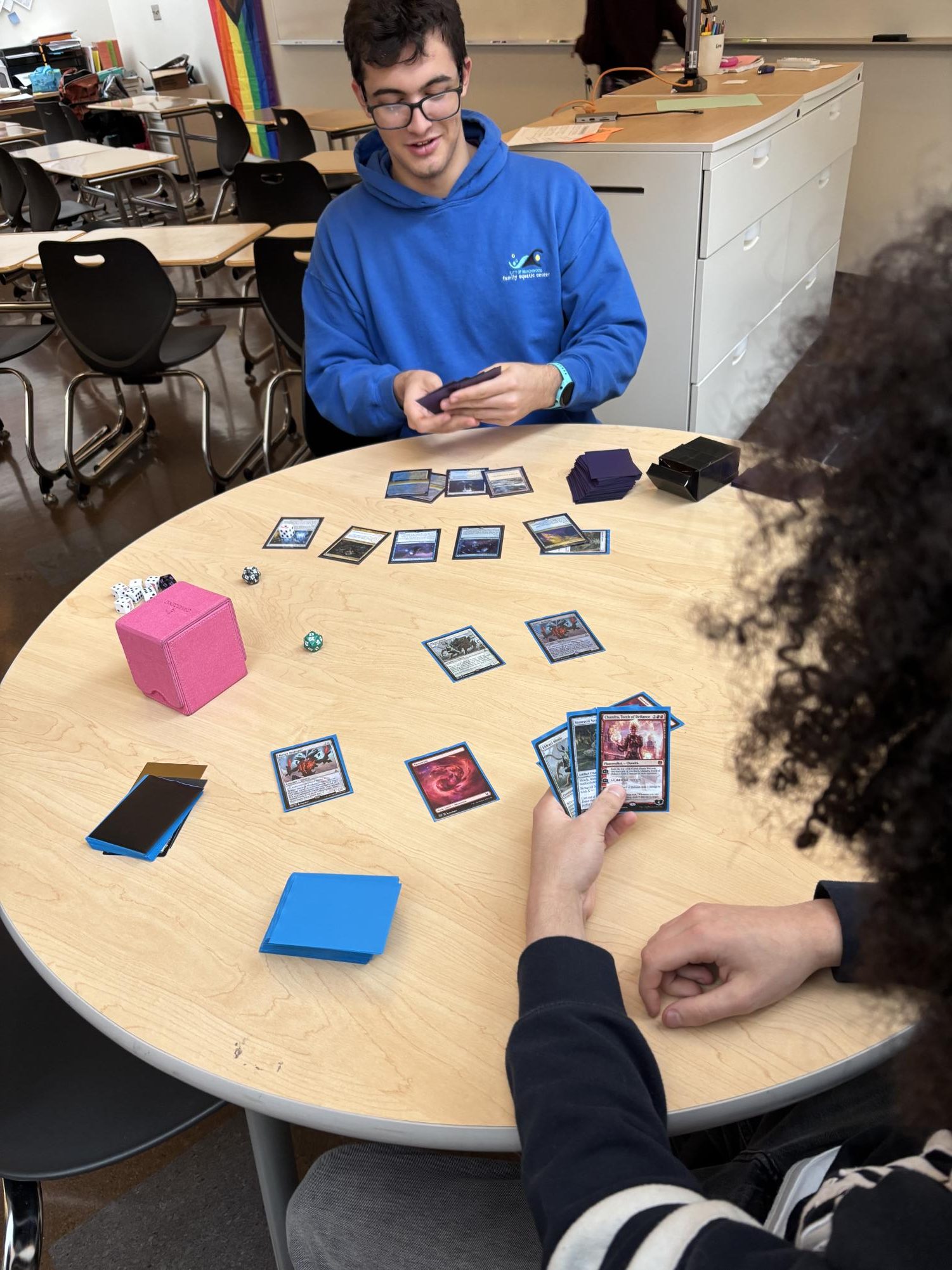 Mayer Bergman and Meir Bickert play magic at a club meeting after school.   
