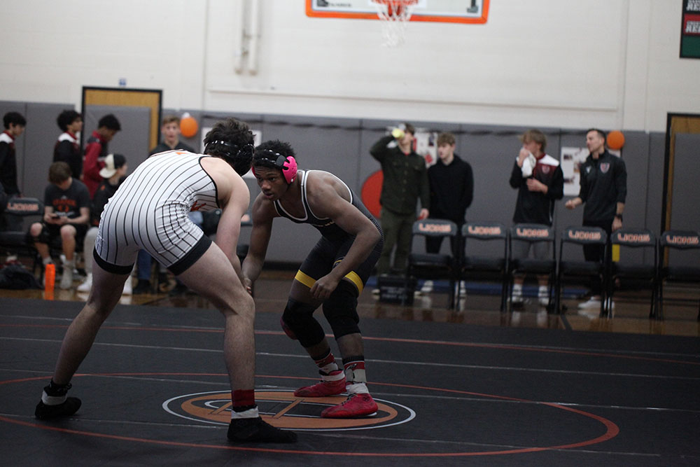 Greenwood circling with an Orange opponent at the Orange tri-meet.