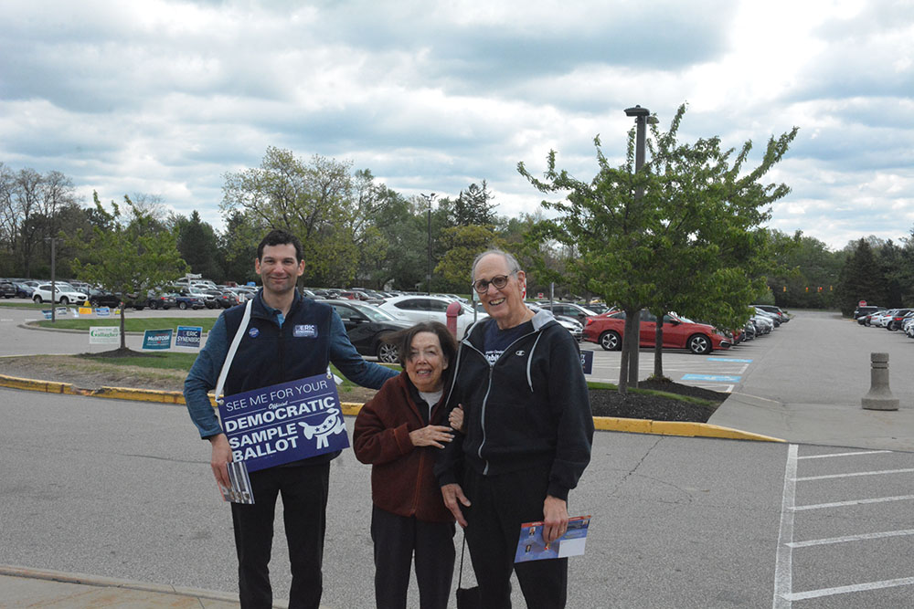 State Rep. Eric Synenberg stands with voters outside the polling station.