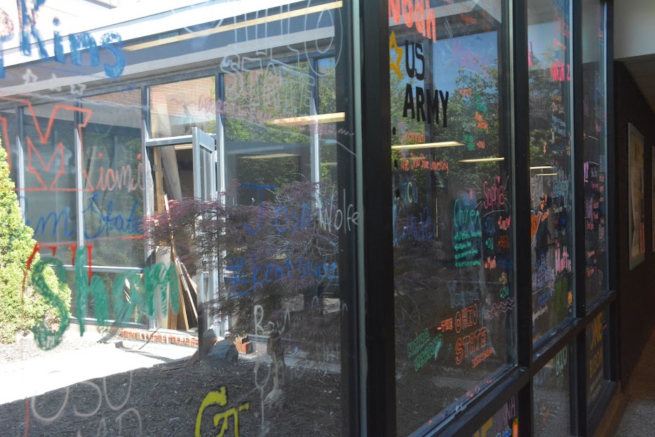 The class of 2026 wrote an extraordinary list of college acceptances on the windows outside the cafeteria.