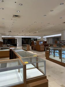 The display cases once featuring designer jewelry and perfume now stand empty.